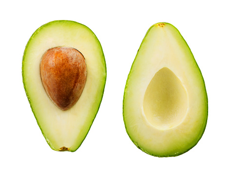 Two slices of avocado isolated on the white background. One slice with core.