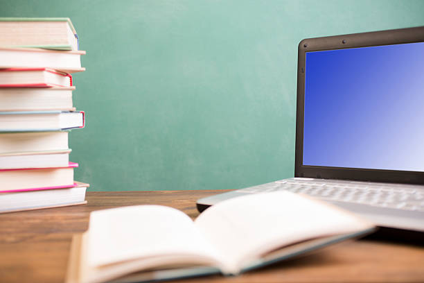 istock Back to school. Education. Textbooks, laptop computer on desk. Chalkboard. 529127876