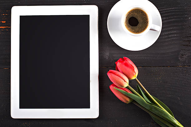 istock tablet computer,  tulips and a cup of coffee 529127894