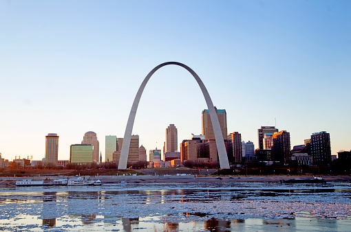 Aerial still image of The Gateway Arch, sitting beyond the Mississippi River taken by a drone on a hazy night in St. Louis, Missouri. \n\nAuthorization was obtained from the FAA for this operation in restricted airspace.