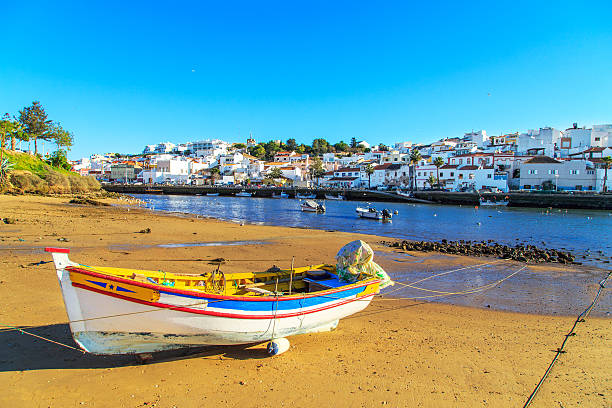 Boats in warm sunset light on the beach in Portimao, Portugal Boats in warm sunset light on the beach in Portimao, Portugal albufeira photos stock pictures, royalty-free photos & images