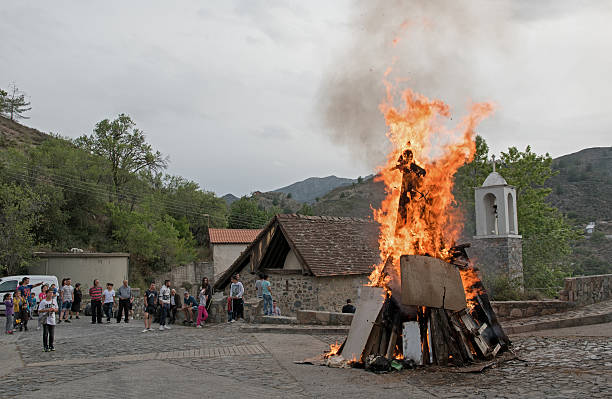 Easter traditional celebrations Cyprus Palaichori, Cyprus - May 2 2016: People outside a church with fire burning (lampratzia)  Judas Iscariot effigy who betray Jesus Christ  for Easter Celepbration at the village of Palaichori in Cyprus judas stock pictures, royalty-free photos & images