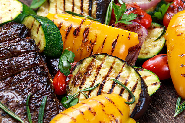 istock Beef steak and Grilled vegetables. On cutting dark board. 529130872