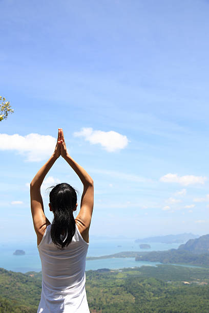 istock young woman practice yoga at mountain peak 529131184