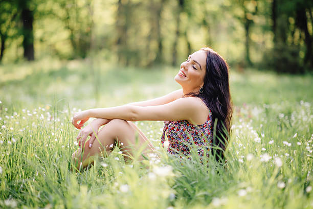 istock sunny summer day, a beautiful young woman lying on the 529133390