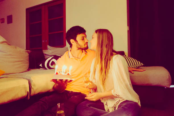 Celebrating Anniversary at home French couple celebrating their anniversary at home. wide cake stock pictures, royalty-free photos & images