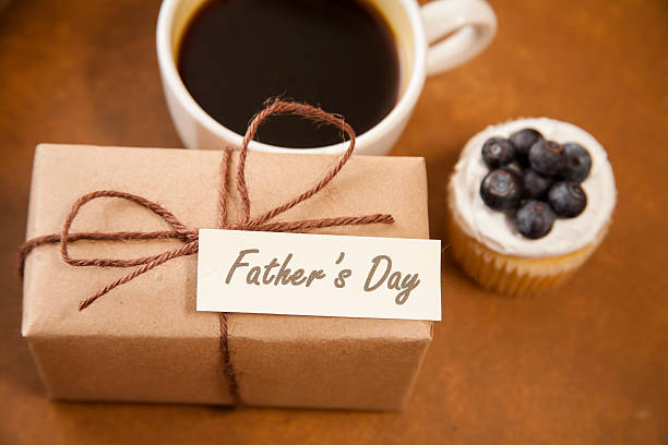 istock Holidays:  Father's Day wrapped gift for dad. Coffee, muffin. 529135184