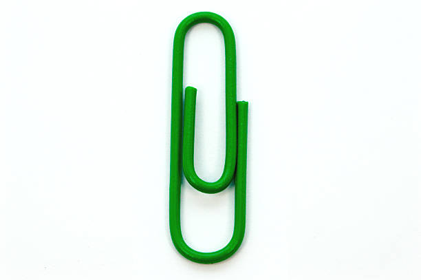 Green paper clip on white background