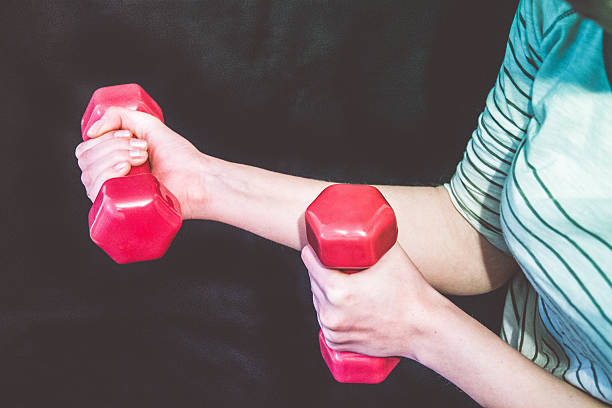 istock Fit woman lifting weights 529135656