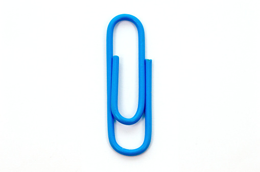 Paper clips lined on red background