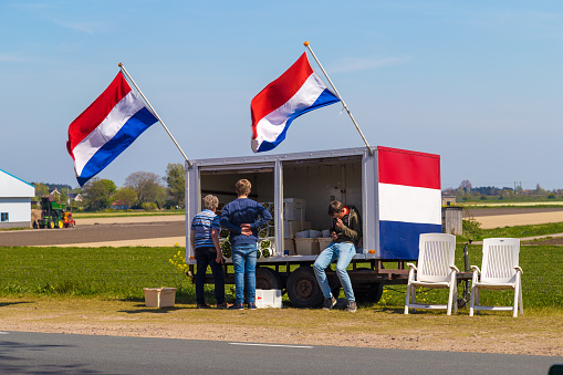 Lisse, Netherlands, The - May 6, 2016: Dutch flower stall selling flowers next to tulip field near village of Lisse, the Netherlands