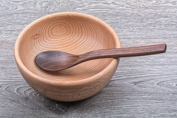 istock A wooden bowl with a spoon on a wooden background 529138228