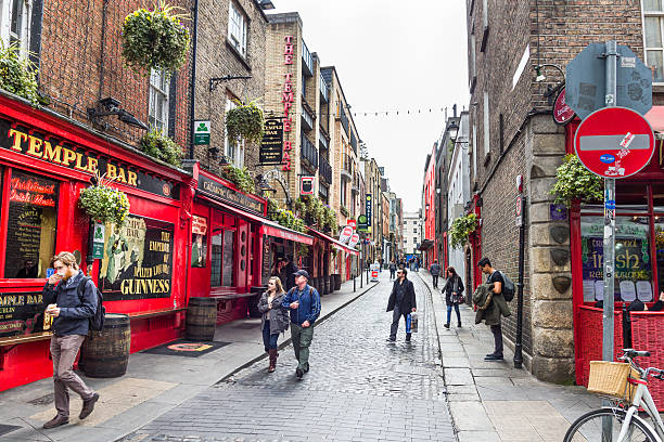Tourists walking in the Temple Bar area Dublin, Ireland - 05 May, 2016: Tourists walking in the Temple Bar area.  temple bar pub stock pictures, royalty-free photos & images