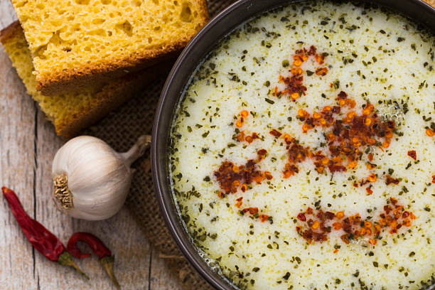 Bowl of soup with bread and garlic Bowl of soup with bread and garlic on the wooden table plateau photos stock pictures, royalty-free photos & images