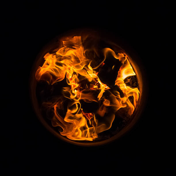 Flames burning in oak barrels for firing its inner side