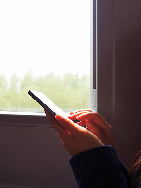 istock Woman using smart phone traveling on train 529139236
