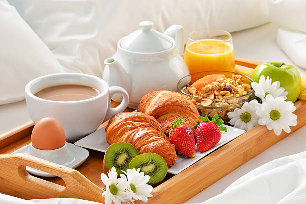 istock Breakfast tray in bed in hotel room 529143296