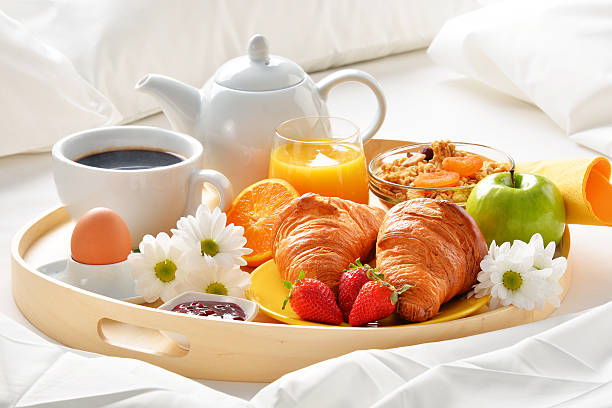 istock Breakfast tray in bed in hotel room 529143388