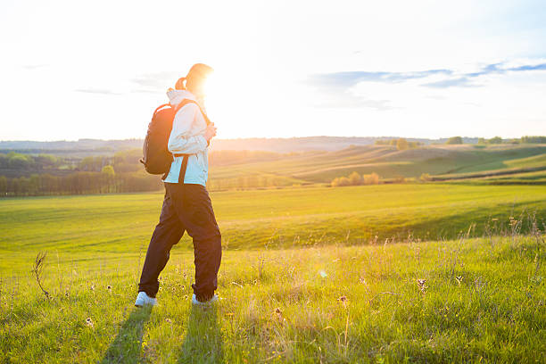 istock Young woman with backpack in a field. 529143748
