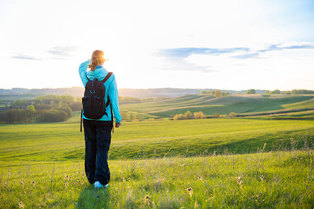 istock Fresh and healthy female model during hike outdoors in field. 529143816