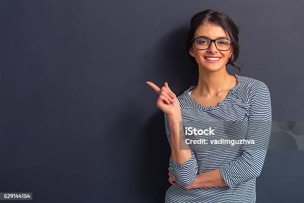 Attractive Young Woman Stock Photo - Download Image Now - Pointing, Beckoning, Women
