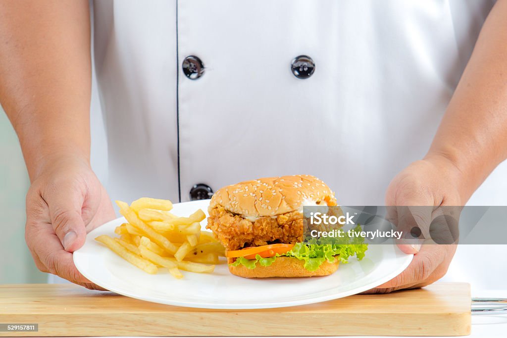 chief chef holding fried chicken burger Bread Stock Photo