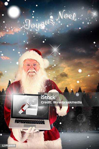 Composite Image Of Santa Claus Presents A Laptop Stock Photo - Download Image Now - 80-89 Years, Active Seniors, Adult