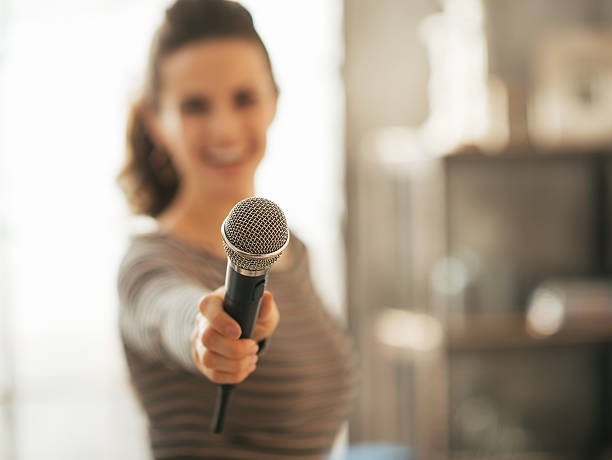 istock closeup on young woman stretching microphone in camera 529162301