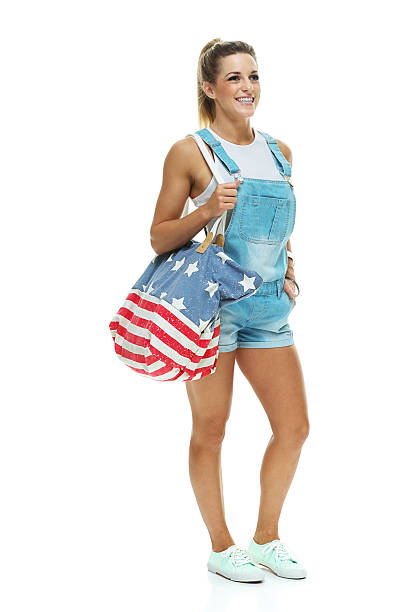 istock Cheerful woman holding purse & looking away 529163777