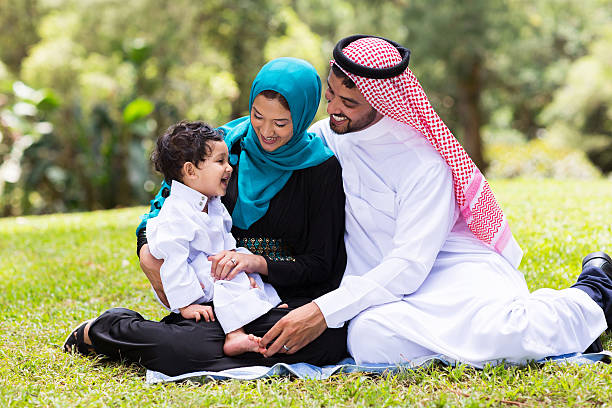 musulmani famiglia seduto all'aperto - ghoutra foto e immagini stock