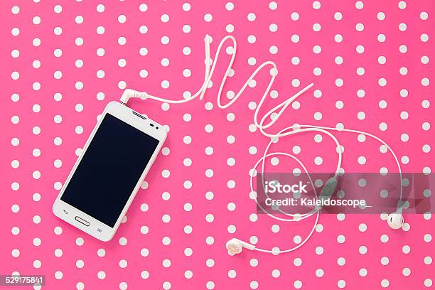 Mobile Phone On Pink Vintage Paper With Dots Stock Photo - Download Image Now - Arts Culture and Entertainment, Audio Equipment, Black Color