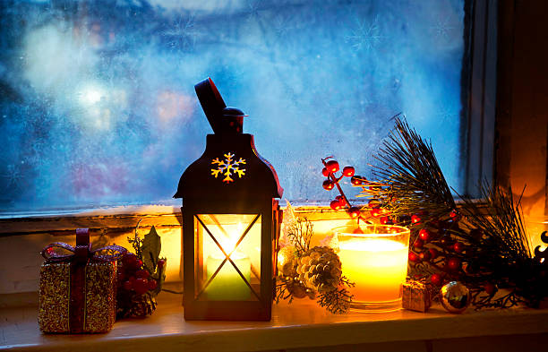 Warm Lantern on Frozen Window with Decoration