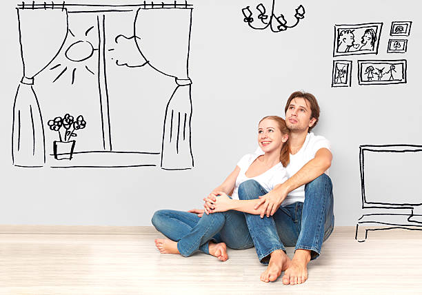 istock happy couple in  new apartment dream and plan interior 529180515