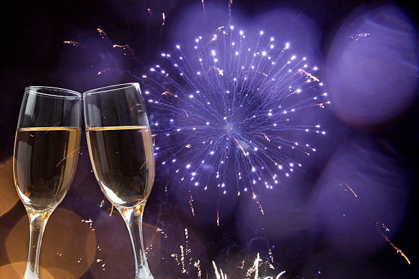 istock Glasses with champagne against fireworks 529190969
