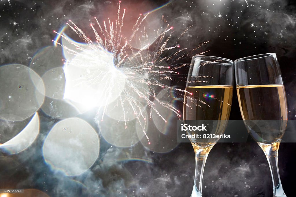 Glasses with champagne against fireworks Glasses with champagne against nigth sky with fireworks Alcohol - Drink Stock Photo