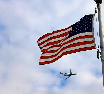 Plane flying over the American Flag