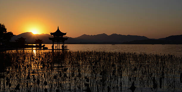 istock Chinese temple in west lake with sunset 529195923