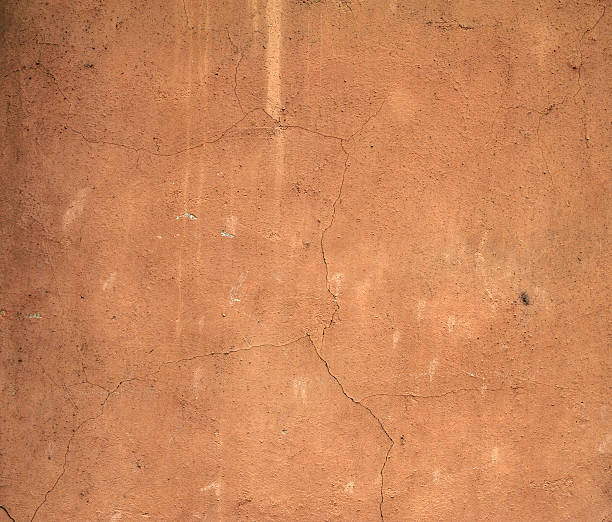 istock Texture of old wall covered with brown stucco 529196605