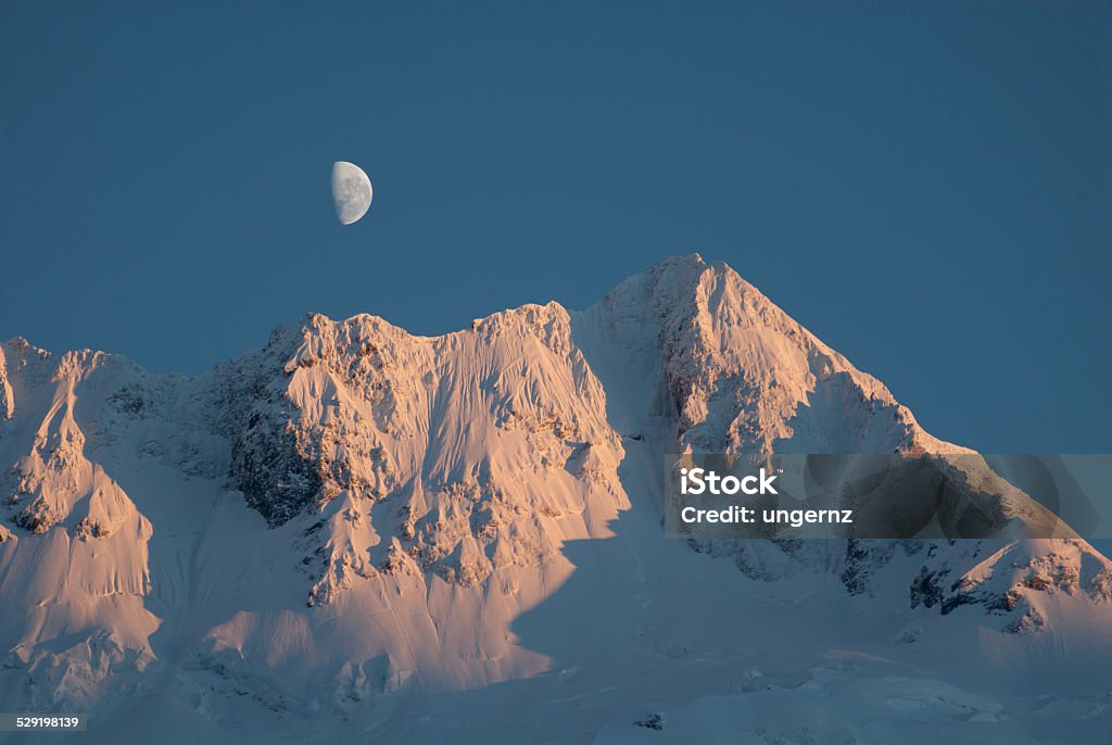 Moon Rise Over Mt Sefton, New Zealand Moon Rise at dawn over Mt Sefton, Mt Cook National Park, New Zealand Cold Temperature Stock Photo