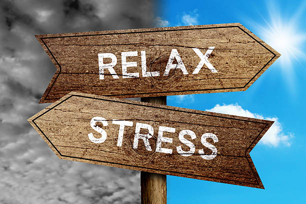 Relax Or Stress Relax Or Stress concept road sign with cloudy and sunny sky background. relief carving stock pictures, royalty-free photos & images