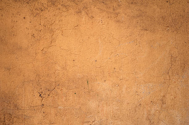 istock Texture of old  wall covered with yellow stucco 529206645