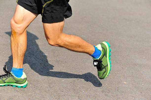 istock marathon runner athlete running on city road. 529208503