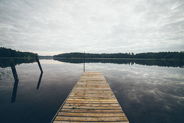 istock reflection of clouds in the lake with boardwalk. Retro grainy 529208923