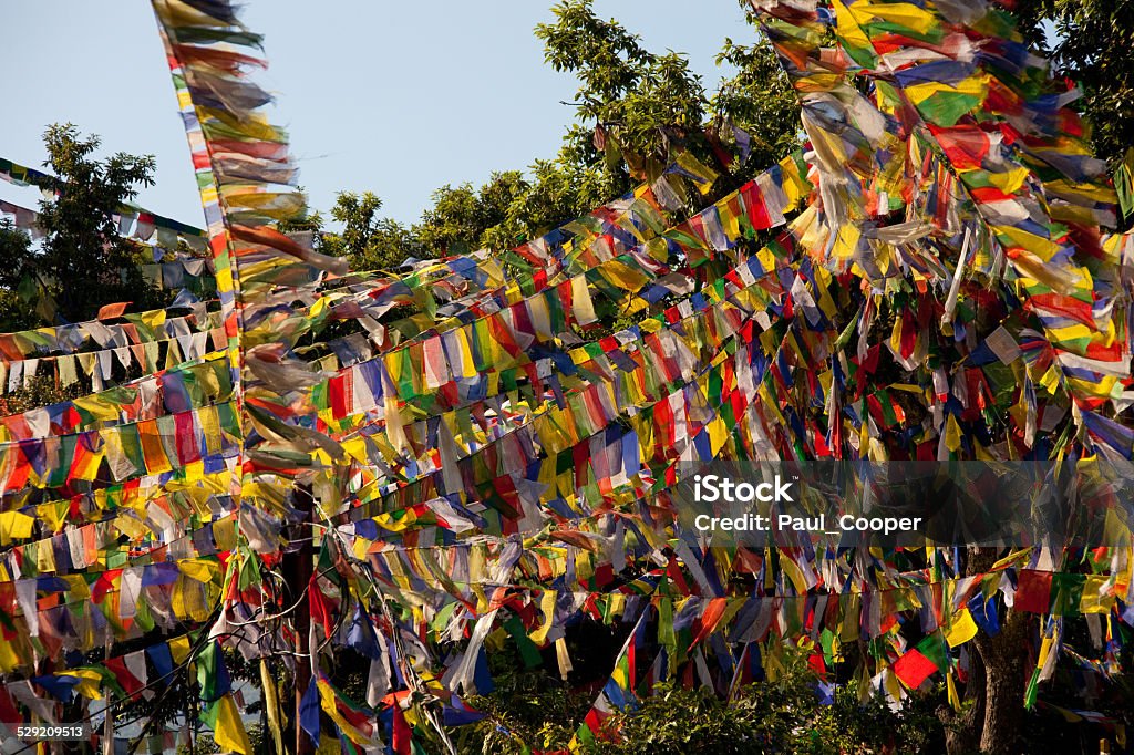 Mass of prayer flags. Mass of prayer flags at the Swayambhunath temple, also known as the monkey temple, hung to send prayers off on the wind. Buddhism Stock Photo