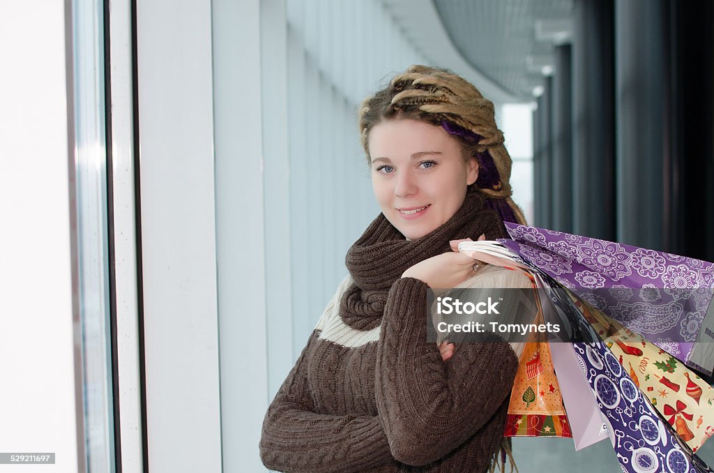 What a great sale! Pretty young woman holding shopping bags on her back and smiling 20-24 Years Stock Photo