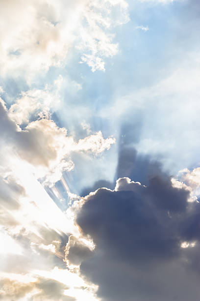 istock Ray of lights sunbeams break through thick clouds 529220199