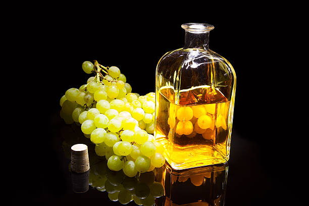 istock Bottle of brandy and grapes 529220429