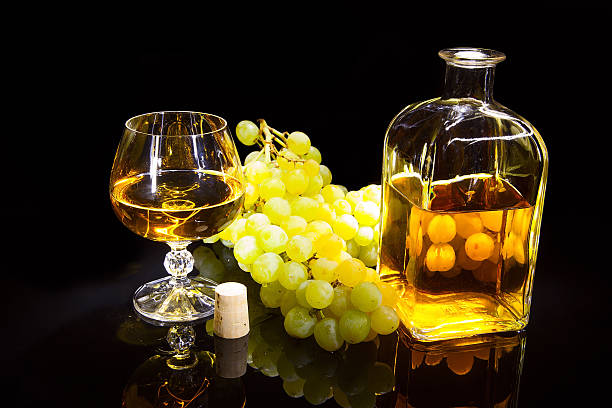 istock Bottle with a glass of brandy and grapes 529220433