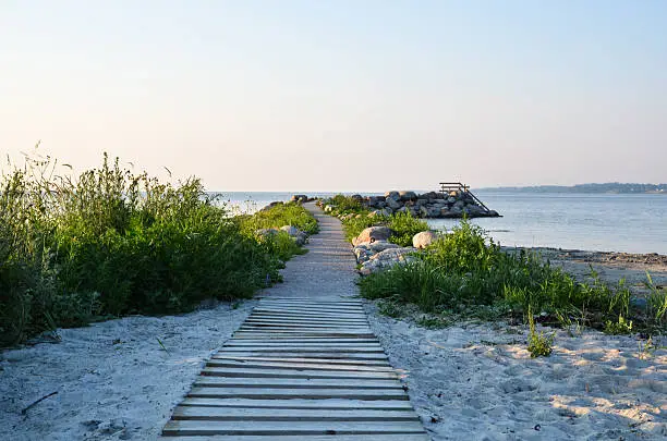 Wooden footpath winding to the beach at the swedish island Oland