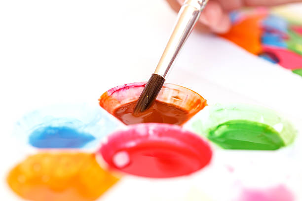 istock Close up hand holding brush with water paint tray 529224085